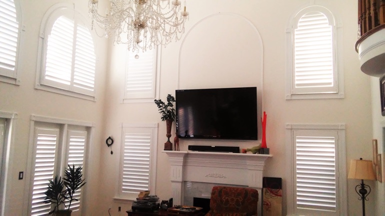 Chicago great room with wall-mounted TV and high-ceiling windows.